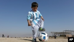 Murtaza Ahmadi, a 5-year-old Afghan Lionel Messi fan plays with a soccer ball. He and his family recently moved to Pakistan due to safety concerns.