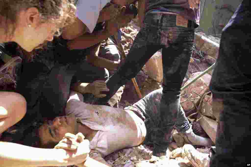 A man is rescued from a collapsed building in the Condesa neighborhood of Mexico City after an earthquake in Mexico, Sept. 19, 2017.