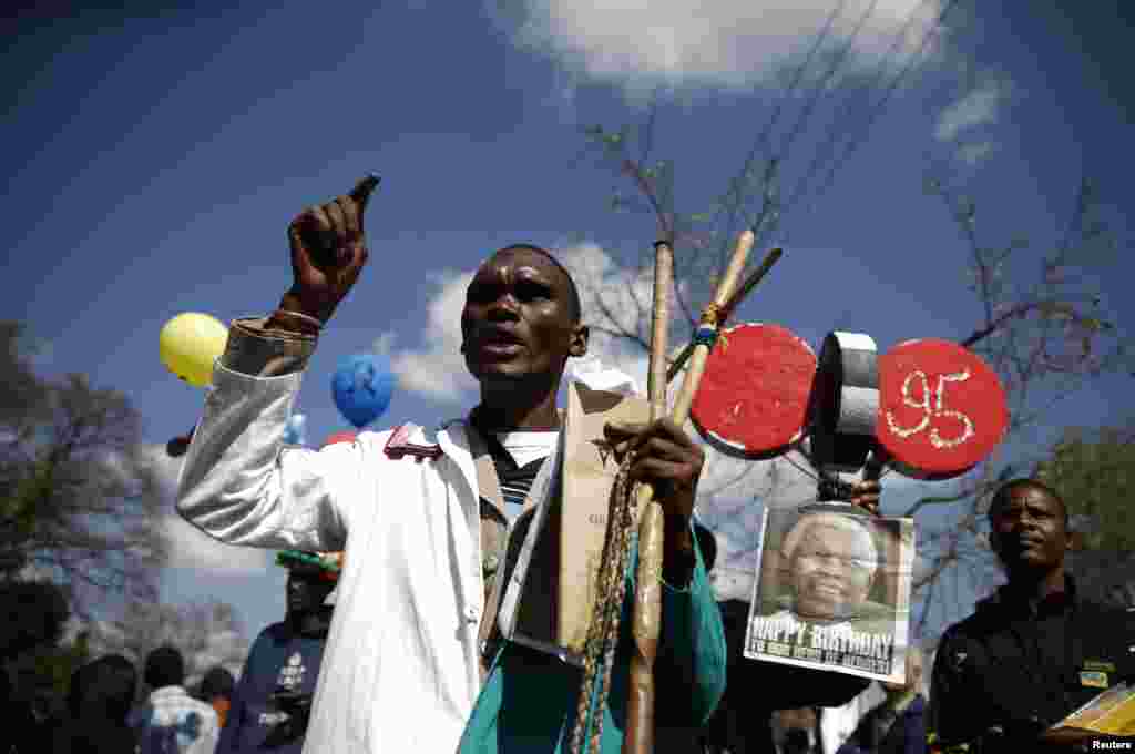 A man prays as well-wishers gather to wish Mandela happy birthday outside Mediclinic Heart Hospital, July 18, 2013.
