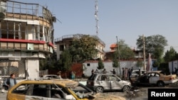 FILE - amaged cars are seen at the site of yesterday's night-time car bomb blast in Kabul, Afghanistan, Aug. 4, 2021.