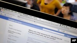 FILE - Facebook's User Operations Safety Team workers look at reviews at Facebook headquarters in Menlo Park, Calif., Tuesday, Dec. 13, 2011. 