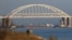 FILE - A Russian cargo ship is seen beneath a bridge connecting the Russian mainland with the Crimean Peninsula after three Ukrainian navy vessels were stopped by Russia from entering the Sea of Azov via the Kerch Strait in the Black Sea, Crimea, Nov. 25, 2018.