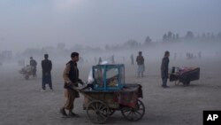 Street vendors push their carts in Chaman-e-Hozori park, Kabul, Afghanistan, Dec. 3 , 2021.