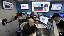 FILE - Microsoft control technician Ray Nichols monitors energy usage in real time at Microsoft Corp.'s operations center in Redmond, Wash.