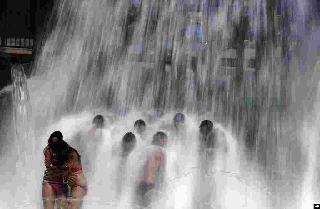 People cool off at the water park during the "Circuit" — the international gay festival in Vilassar de Dalt, Spain.