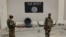 FILE - Soldiers stand at a checkpoint in front of a Boko Haram flag the Nigerian city of Damasak, Nigeria, March 18, 2015. In Senegal, 29 suspects are awaiting a ruling on terrorism-related charges. Most of the suspects are believed to have fought for Boko Haram in Nigeria, while others fought for jihadists in Libya and Mali.