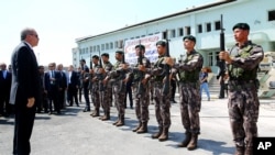 Turkey President Recep Tayyip Erdogan, left, reviews officers of the special police forces, at their headquarters in Ankara, Turkey, Friday, July 29, 2016.