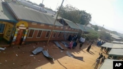 FILE - People gather at the scene of an attack in the town of Mandera, Kenya, near the border with Somalia, Oct. 25, 2016. 
