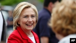 Democratic presidential candidate Hillary Rodham Clinton greets a spectator at a Fourth of July parade, July 4, 2015, in Gorham, N.H. 