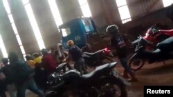 Employees react amid the chaos as Chinese and Indonesian workers clash at a nickel smelter in Morowali, Sulawesi, Indonesia in this undated social media video released Jan. 16, 2023. Revi Limbong via REUTERS