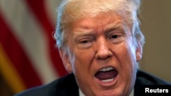 FILE - President Donald Trump announces that the United States will impose tariffs of 25 percent on steel imports and 10 percent on imported aluminum during a meeting at the White House in Washington, March 1, 2018. The White House press secretary said March 7 that "potential carve-outs for Mexico and Canada" and perhaps others are under consideration.