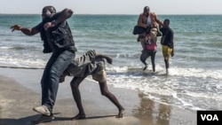 Gambian journalists Sheriff Bojang Jr., left, and Abdoulie John arrive in Banjul for the first time in years. Bojang has been in exile since 2007 and John since 2013 — this is their fist time being home in years. (Photos by Ricci Shyrock/VOA)