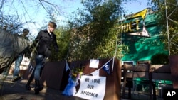 Pedestrians pass by the front door of Comet Ping Pong pizza shop, in Washington, D.C., Dec. 5, 2016. A fake news story prompted a man to fire a rifle inside the popular eatery as he attempted to "self-investigate" a conspiracy theory of a child sex ring being operated from there, police said.