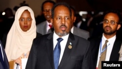Somali's President Hassan Sheikh Mohamud is escorted as he leaves a meeting of the 28th Ordinary Session of the Assembly of the Heads of State and the Government of the African Union in Ethiopia's capital Addis Ababa, Jan. 30, 2017.