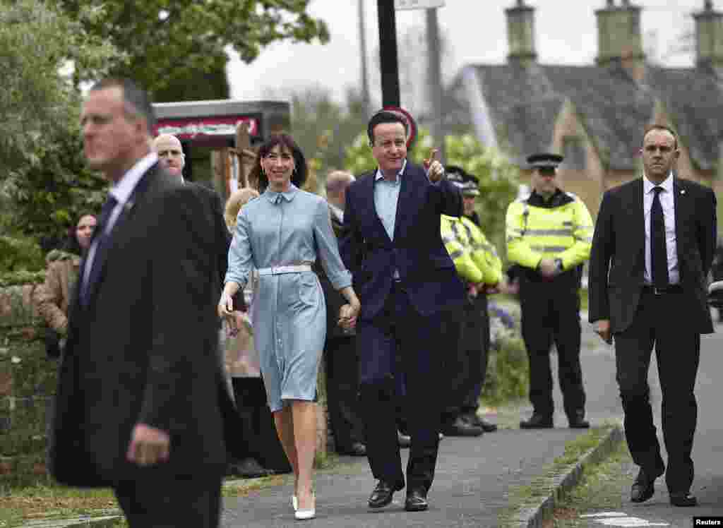 Prime Minister David Cameron arrives with his wife Samantha to vote in Spelsbury, May 7, 2015.