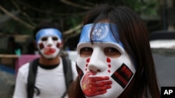 In this April 4, 2021, file photo, young demonstrators participate in an anti-coup mask strike in Yangon, Myanmar. 