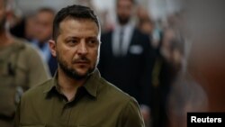 Ukraine's President Zelenskiy and Polish President Duda attend a church service in Lutsk