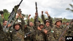 Moro Islamic Liberation Front (MILF) rebels celebrate the signing of the peace agreement during a rally at Camp Darapanan, Sultan Kudarat town, in southern island of Mindanao, March 27, 2014. Some think Islamic State could take advantage of the frustrations of Muslims in the southern region of Mindanao over the federal legislature's failure to ratify a peace deal.