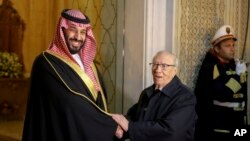 Tunisian President Beji Caid Essebsi, right, shakes hands with Saudi Crown Prince Mohammed bin Salman in Carthage near Tunis, Nov. 27, 2018. The crown prince is visiting allies in the Middle East before heading to a G-20 summit in Argentina later this week.