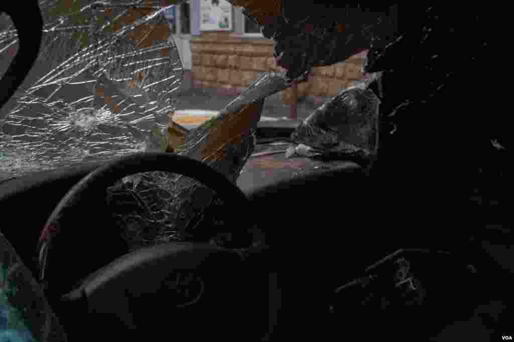 A burnt-out car is seen near a telecom in Nagorno-Karabakh, Oct. 9, 2020. (Yan Boechat/VOA)