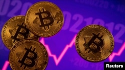 FILE PHOTO: A representation of virtual currency Bitcoin is seen in front of a stock graph in this illustration taken March 15, 2021. REUTERS/Dado Ruvic/Illustration/File Photo