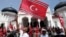 An Acehnese man waves a Crescent-Star flag during a rally outside Baiturrahman Grand Mosque in Banda Aceh, Aceh province, Indonesia, April 1, 2013.