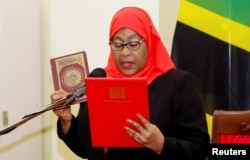 FILE - Tanzania's President Samia Suluhu Hassan takes the oath of office in Dar es Salaam, Tanzania, March 19, 2021.