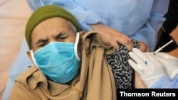 FILE - A man receives the COVID-19 vaccine during a national coronavirus vaccination campaign, in Sale, Morocco, Jan. 29, 2021.