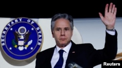 U.S. Secretary of State Antony Blinken gestures as he arrives in Abu Dhabi, during his week-long trip aimed at calming tensions across the Middle East, in United Arab Emirates, Jan. 7, 2024.