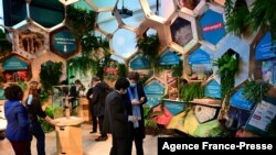 FILE - Delegates attend the COP26 U.N. Climate Change Conference at the Scottish Event Campus in Glasgow, Scotland, Oct. 31, 2021. 