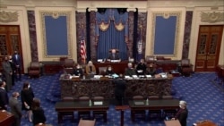 U.S. House lead impeachment manager Jamie Raskin, D-MD, hands over the House article of impeachment against former President Donald Trump, on the floor of the U.S. Senate in this this frame grab from video shot at the U.S. Capitol, Jan. 25, 2021.
