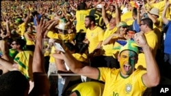 Brazil soccer fans celebrate their team's victory over Chile after a penalty shootout at a World Cup round of 16 match, Mineirao Stadium, Belo Horizonte, June 28, 2014.
