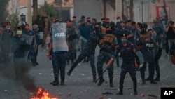 Security forces try to disperse demonstrators during ongoing anti-government protests near Tahrir square, Baghdad, Iraq, July 27, 2020. 