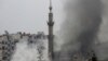 Smoke rises from a mosque and another building during heavy fighting in the Jobar area of Damascus Feb. 6, 2013. 