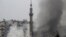 Smoke rises from a mosque and another building during heavy fighting in the Jobar area of Damascus Feb. 6, 2013. 