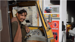 Pakistani driver Jalal filling his vehicle with smuggled Iranian fuel that he said was cheaper legally-sold fuel, on Eastern Bypass road of Quetta.