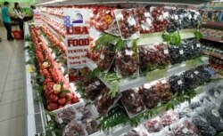 FILE - Imported American grapes and apples are on display at Fivimart supermarket in Hanoi, Oct. 23, 2012.