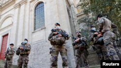 French soldiers, part of France's national security alert system "Sentinelle", patrol near the Cathedral in Arras as France has raised the security alert for French territory to the highest level after the knife attack in the city of Nice, France.