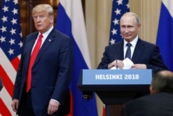 FILE - U.S. President Donald Trump, left, and Russian President Vladimir Putin arrive for a press conference after their meeting at the Presidential Palace in Helsinki, Finland, July 16, 2018.