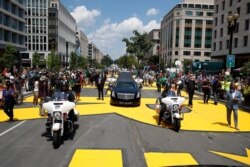 The hearse with the flag-draped casket of Rep. John Lewis, D-Ga., drives on 16th Street, renamed Black Lives Matter Plaza, near the White House, July 27, 2020.