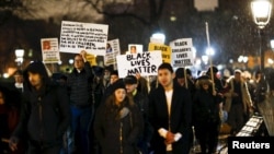 People march as they take part in a protest against the police in Manhattan, New York, after a grand jury cleared two Cleveland police officers in the November 2014 fatal shooting of Tamir Rice, Dec, 28, 2015.