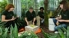 Smithsonian botanist Vicki Funk (2nd from left) and student team at the U.S. Botanic Garden prepare a specimen for the museum’s herbarium, July 2015. (Credit: James Di Loreto/Smithsonian Institution)