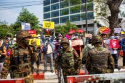 Soldiers stand outside Myanmar's Central Bank during a protest against the military coup, in Yangon, Myanmar, Feb. 15, 2021.