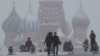 FILE - People walk in Red Square during heavy snowfall in Moscow, Russia, Jan 27, 2019.