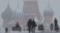 FILE - People walk in Red Square during heavy snowfall in Moscow, Russia, Jan 27, 2019.