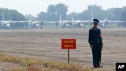 FILE - A Vietnamese soldier stands guard in front of military aircraft near a dioxin contaminated area while then-U.S. Defense Secretary Jim Mattis visits Bien Hoa air base in Bien Hoa, outside Ho Chi Minh City, Oct. 17, 2018. 