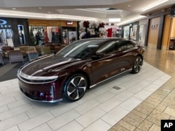 FILE - A 2023 Lucid Air touring sedan sits on display in a mall late Friday, Dec. 15, 2023, in Denver. (AP Photo/David Zalubowski)