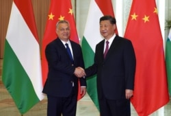FILE - Hungarian Prime Minister Viktor Orban, left, shakes hands with Chinese President Xi Jinping during a meeting on April 25, 2019, as part of the second Belt and Road Forum in Beijing.