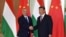 FILE - Hungarian Prime Minister Viktor Orban, left, shakes hands with Chinese President Xi Jinping during a meeting on April 25, 2019, as part of the second Belt and Road Forum in Beijing.