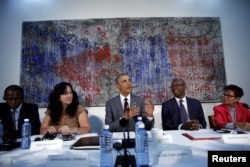 FILE - U.S. President Barack Obama attends a meeting with Cuban dissidents at the U.S. embassy in Havana, Cuba, March 22, 2016. On the wall behind Obama is a painting, "My New Friend," donated to the embassy by Michel Mirabal, a Cuban artist.